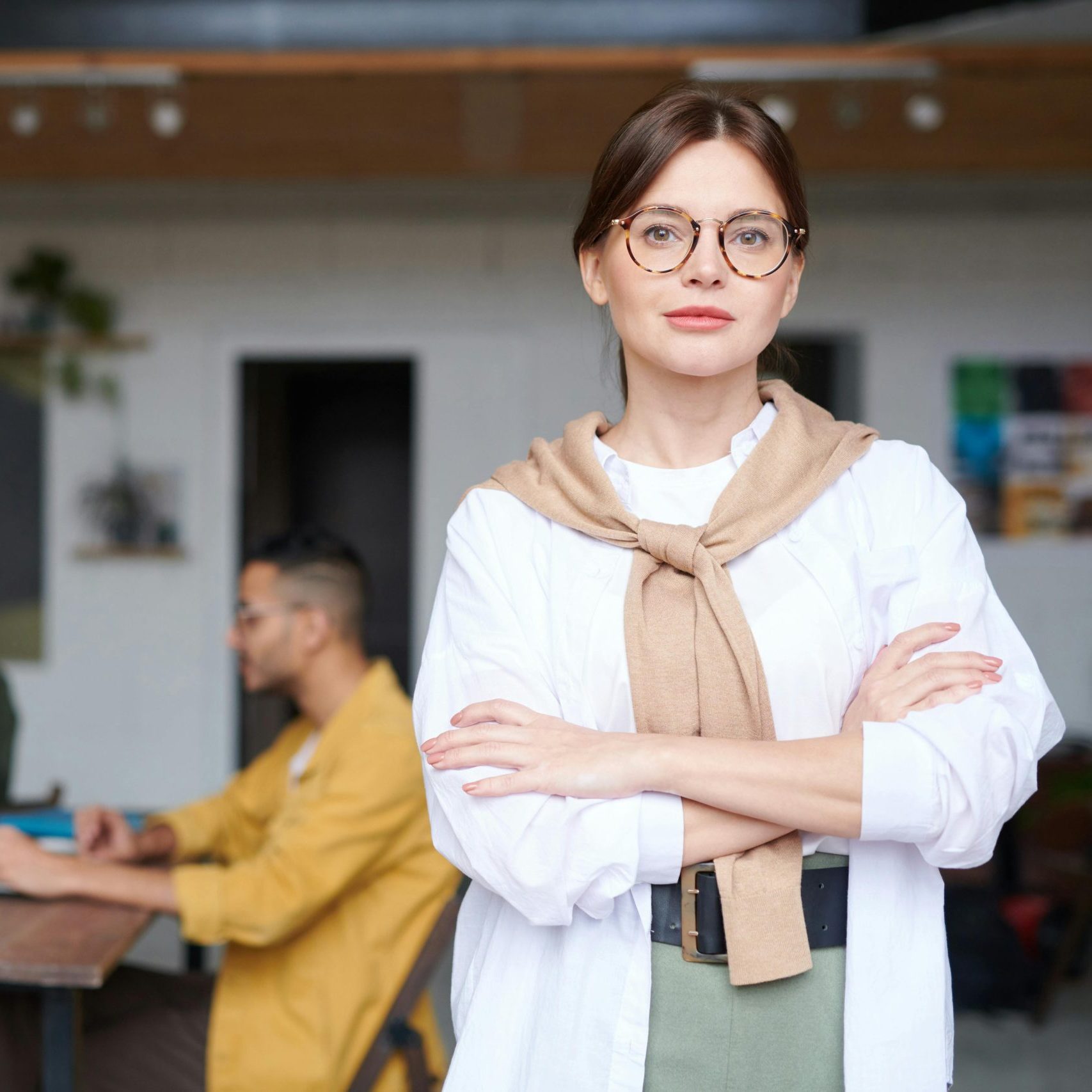 Confident businesswoman in a modern office space, embodying success and leadership.